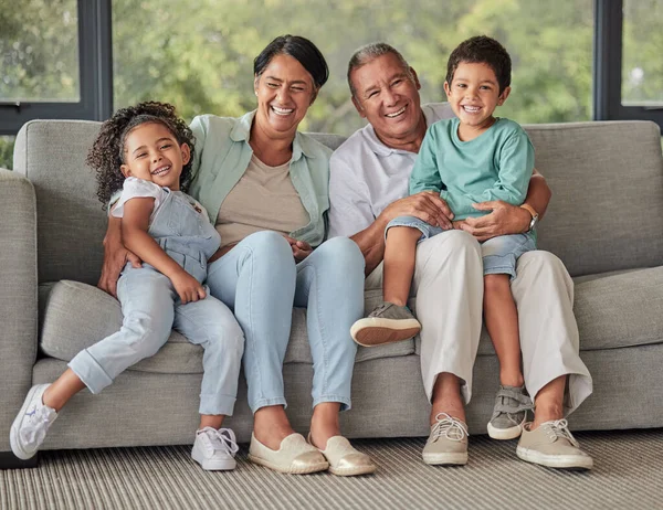 Laughing grandparents, children and bonding on sofa in Brazil house or home living room in trust, security or safety. Family portrait, smile or comic kids with retirement senior man and woman support.