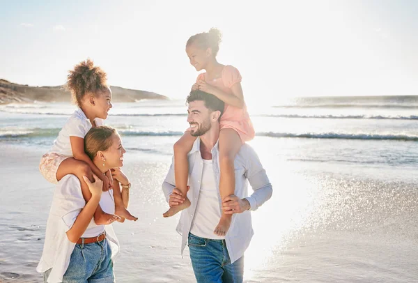 Nature, smile and happy family at the beach to relax in freedom, peace and memories together in summer. Travel, mother and father in an interracial relationship carrying children on holiday at sea.