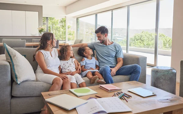 Happy family, children and parents talking on a sofa, relax and bonding in a living room at home. Love, quality time and affection by interracial family enjoy the weekend and conversation in a house.