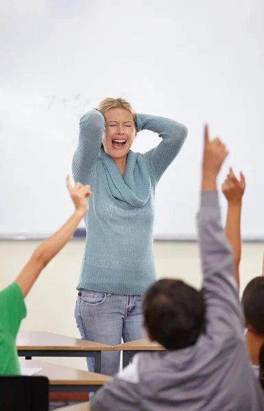 Losing grip on the class. A screaming teacher with her students hands in the air