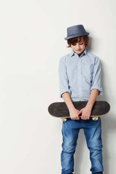 准备用他的风格来吸引姑娘们 可爱的十几岁前男孩穿着时髦的衣服 拿着滑板 与白人隔离 — 图库照片