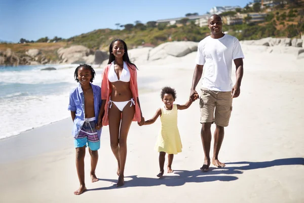 Enjoying the sand between their toes. An african-american family enjoying a day at the beach together