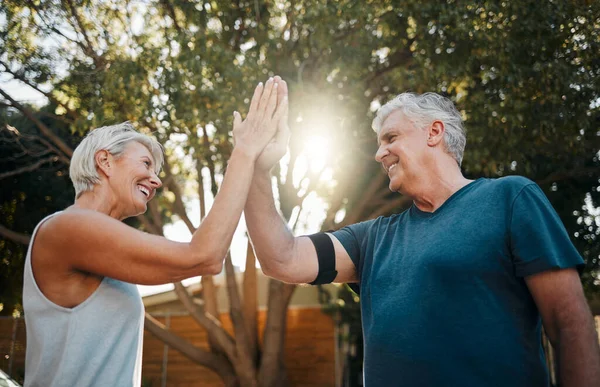 Fitness senior couple high five for support, teamwork and exercise motivation with sunshine, outdoor exercise and wellness. Success, achievement or target goal of elderly people for workout results.