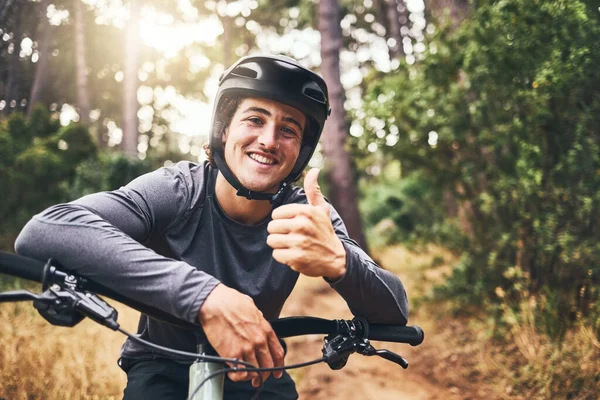 Thumbs up man rider on mountain bicycle happy riding or training for fitness, wellness and health exercise outdoor. Cycling, active and workout sports athlete smile for success, motivation and cardio.