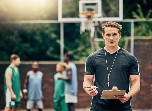 Basketball coach on court training team for game, tournament and competition outside. Confident, trainer and man focus on workout or teamwork to prepare, motivation and plan play strategy at practice.
