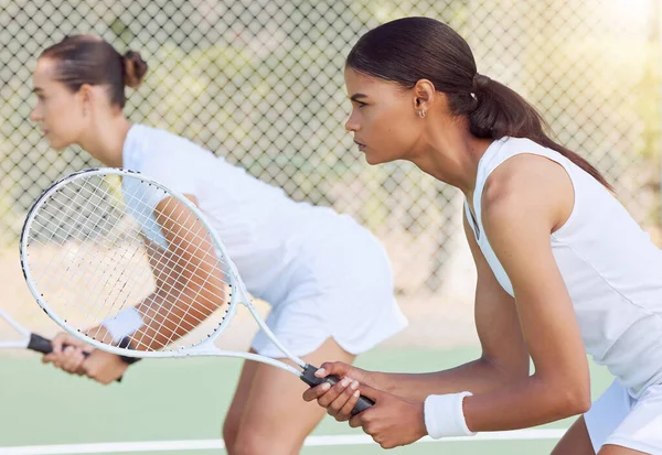 Tennis, doubles match and focus women ready to start game, competition and tournament play in Melbourne, Australia sports court outdoors. Players teamwork, racket bat and athletes training challenge.