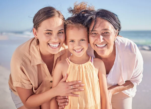 Family, love and children with a girl, mother and grandmother on the beach for summer vacation. Portrait, travel and nature with a senior woman, daughter and kid by the sea or ocean in Hawaii.