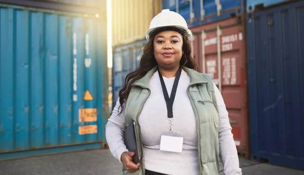 Shipping worker and portrait of black woman at cargo freight containers with tablet for logistics. Assertive, confident and professional African girl in ecommerce delivery management industry