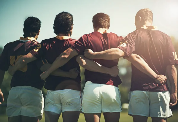 Getting ready for the scrum. Rearview shot of a young rugby team lining up for a scrum