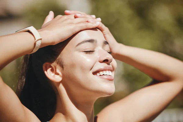 Face, relax and happy woman in sunshine, outdoor fresh air and peaceful break for mental health, wellness and body. Summer, happiness and smile latino girl relax in nature, park rest and calm freedom.