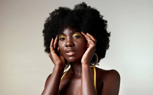 Black woman, fashion and face beauty in makeup against a mockup studio background. Portrait of an isolated beautiful African American model with stylish cosmetic art and afro hair style on copy space.