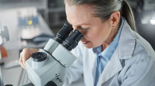 Science, research and microscope with a woman engineer working in her laboratory on innovation and development. Analytics, future and sample with a scientist at work with DNA or RNA in her lab.