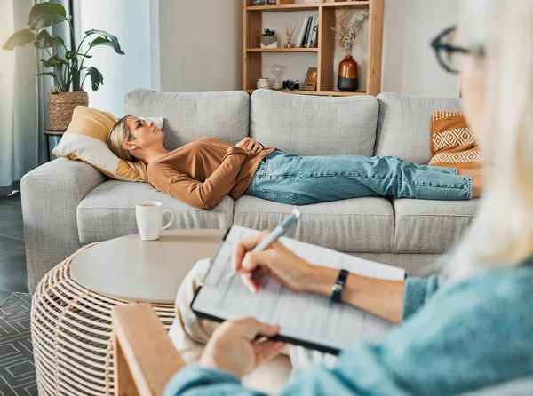 Relax, psychology and therapist with woman patient struggling with depression resting on sofa. Professional psychologist analysis notes for consultation to help emotional mental health client