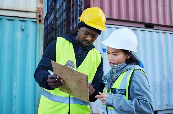Logistics, clipboard and diversity team work on cargo, container and supply chain delivery or shipping inventory checklist. Collaboration, black man and asian woman check product stock or export data.