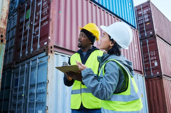 Logistics, shipping management and checklist for cargo stock with man and woman talking delivery at shipyard. Warehouse manager and colleague working on supply chain control for container inspection.