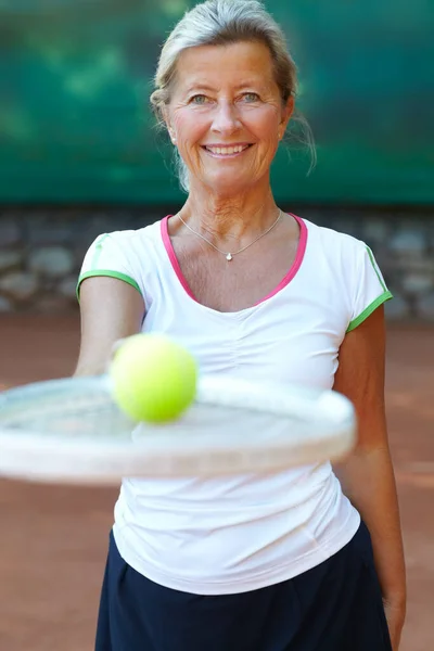 Zagrajmy Tenisa Starsza Kobieta Uśmiecha Się Trzymając Rakietę Tenisową Piłką — Zdjęcie stockowe