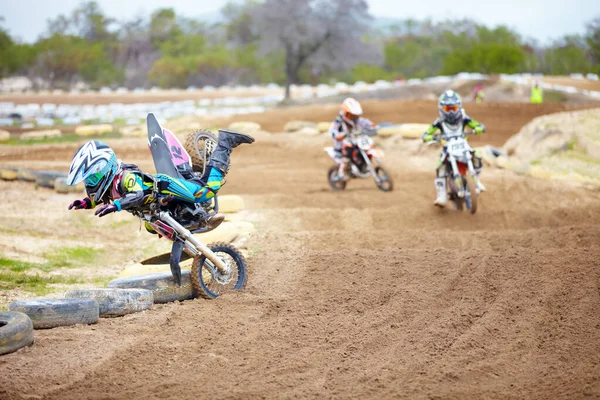 One wrong move and youre outta the race. A motocross rider taking a nosedive on the track