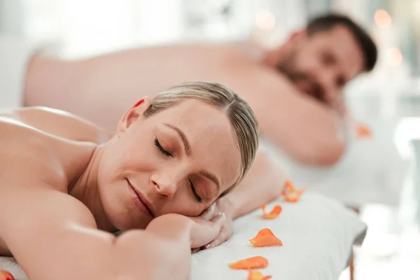 Massage, luxury and couple at a spa to relax, body wellness and sleeping during back therapy at a hotel. Man and woman with sleep during skincare cosmetics treatment on holiday at health salon.