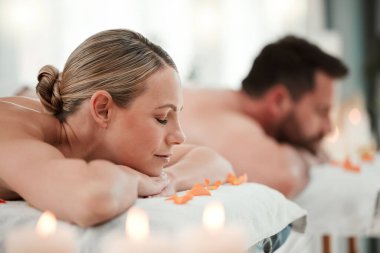 Relax, spa and couple on massage bed table for luxury messaging, zen and calm on vacation in hotel resort. Health, body wellness therapy or body care treatment of man and woman on holiday together. clipart