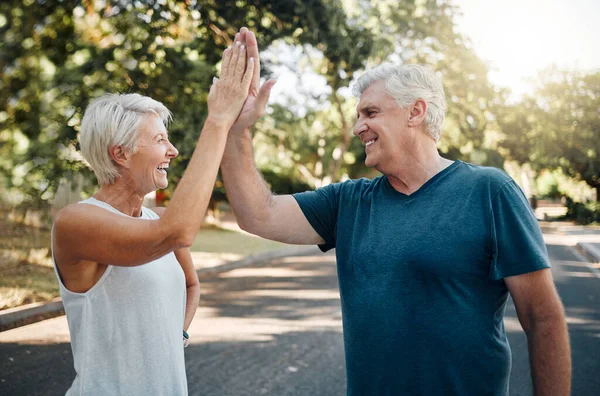 High five, success or senior couple fitness in running workout, exercise or training in nature park or Canada garden. Smile, happy or sports teamwork gesture for retirement man and woman health goals.