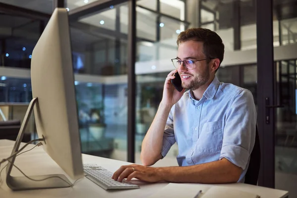 Phone call, night office and computer businessman talking, communication and discussion for networking, planning deal and vision. Male employee mobile conversation, desktop and ideas in dark company.