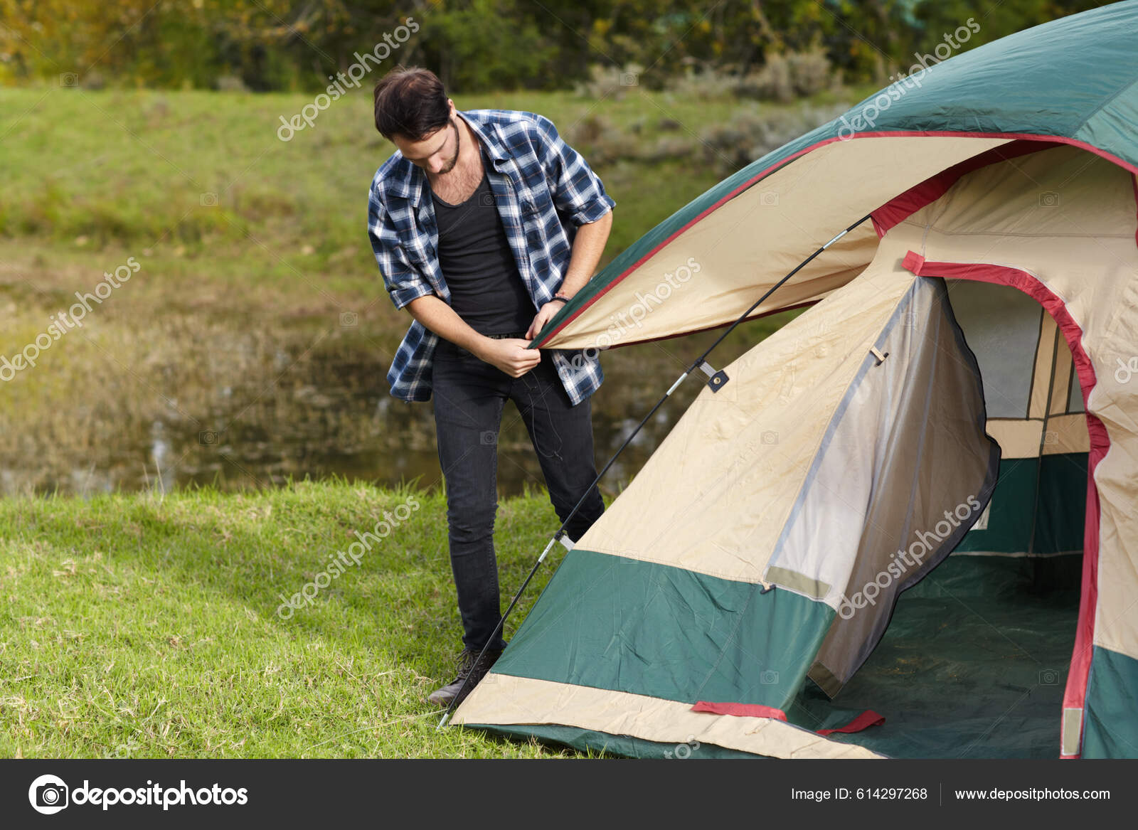 Adding Finishing Touches His Tent Young Man Putting Camping Tent Stock Photo PeopleImages 614297268