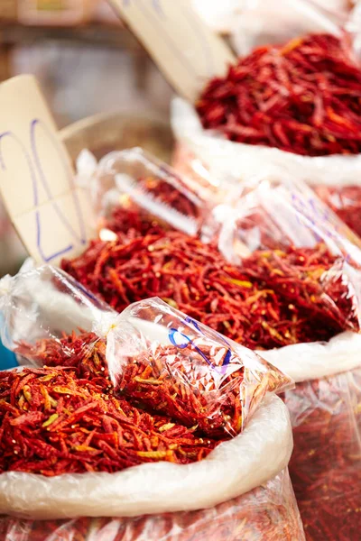 Red chillies at Thai spice market. Bags of dried red Thai chillies for sale at a market