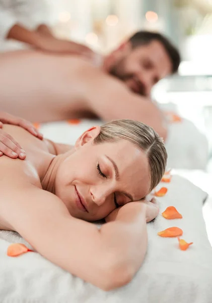 Wellness, beauty and couple massage at spa for health and relax in zen resort, peaceful and happy. Salon, luxury and man and woman enjoy treatment by massage therapist on their vacation in Thailand.