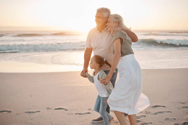 这对成熟的夫妇一起在海滩上散步 和孙子孙女一起散步的快乐的祖父母 小女孩在度假时和祖父母在一起 一个成熟的男人在海滩上拥抱他的妻子 — 图库照片