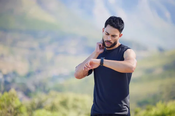 Man on run check pulse, heart rate and body stats for health with smartwatch on nature run. Runner does outdoor exercise for fitness, sports workout and cardio training to increase race running time.