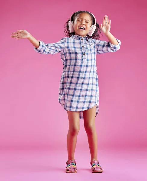 Симпатичная Маленькая Расовая Девочка Вьющимися Волосами Слушающая Музыку Наушниках Розовом — стоковое фото