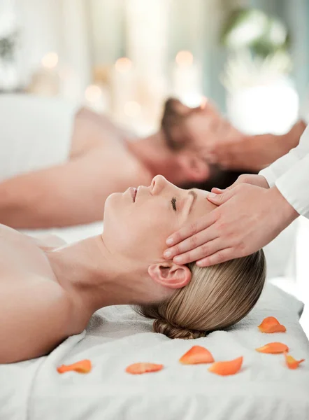 Couple, head massage or relax wellness in hotel, hospitality salon or zen spa in stress release, relax or self care. Reiki hands, man or woman on table bed for peace, headache relief or healthy sleep.