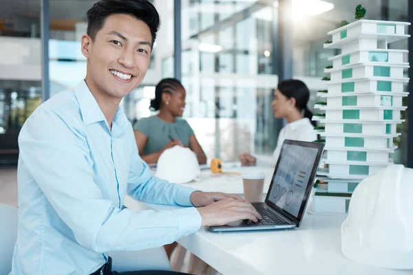 Architect, man with laptop and architecture business, planning strategy and engineering data. Young Asian working, diversity and design model, corporate conference room and smile in portrait