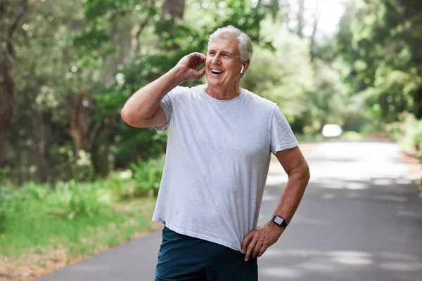Music Helps Push Run Mature Man Wearing Wireless Earphones While — Stock Photo, Image