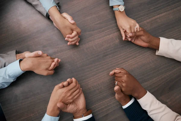 Teamwork, collaboration and business people holding hands before meeting in the office. Diversity, team and support in corporate business with men and women employees connected together in circle.