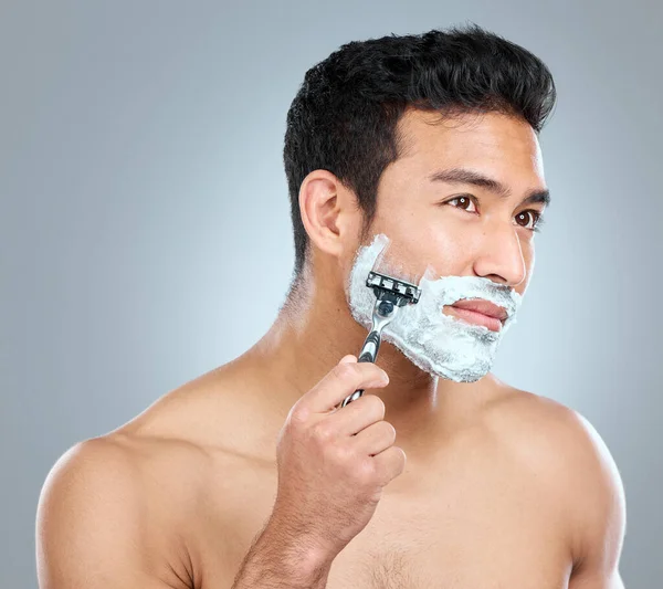 Your skin deserves the best. Studio shot of a man shaving with a disposable razor