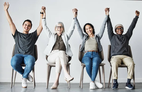 Portrait of diverse recovered addicts. Patients sitting in line at doctors office.Therapist sitting with patients in a row. Happy mixed race colleagues celebrating and looking positive with copyspace.