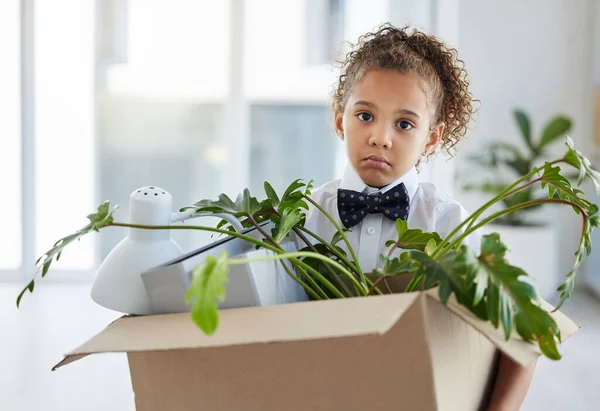 I got fired. an adorable little girl dressed as a businessperson holding a box of her belongings after being fired