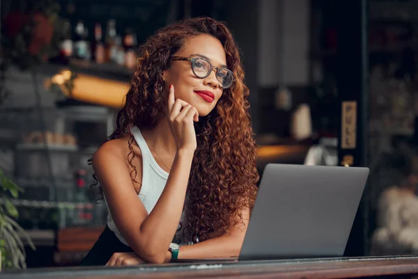 Black woman, working at cafe on laptop and remote work online as digital freelance employee. Modern professional businesswoman, writing web design blog and internet connection to work at coffee shop.