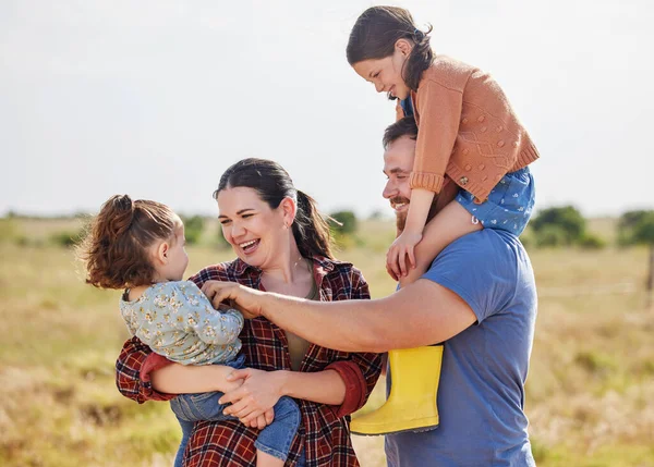 My family means the world to me. a couple on a farm with their two adorable daughters