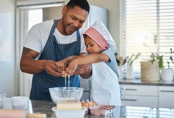 My dad is a chef and I want to be one too. a father baking with his son in the kitchen at home