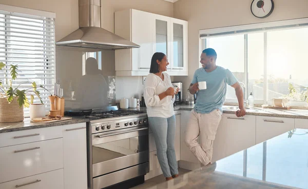 Mornings, coffee and good company. a couple drinking coffee and talking while standing in their kitchen