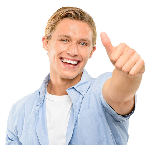 I like that. a handsome young man standing alone in the studio and showing a thumbs up