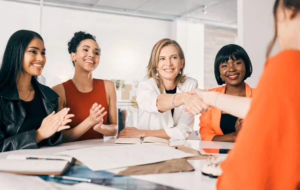 A handshake is all it takes. two businesswomen shaking hands in a meeting at work