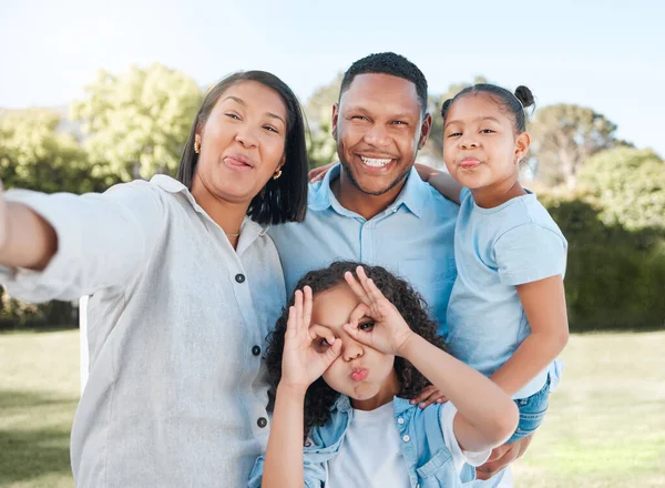 There is no love greater than the love shared within a family. a couple standing outside with their two daughters