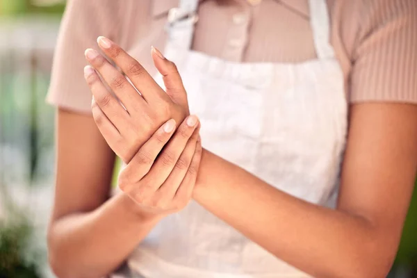 Still got bills to pay. an unrecognizable worker experiencing pain in her wrist while at work