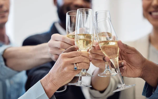We deserve to celebrate after all our success. Closeup shot of a group of businesspeople celebrating while toasting with champagne at work