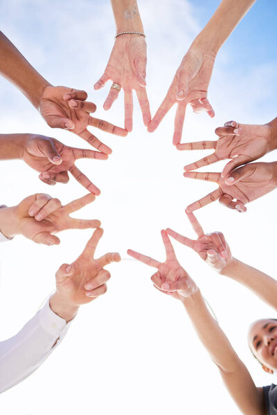 Dont allow your light to be put out. a group of unrecognizable people making a star shape with their fingers outside