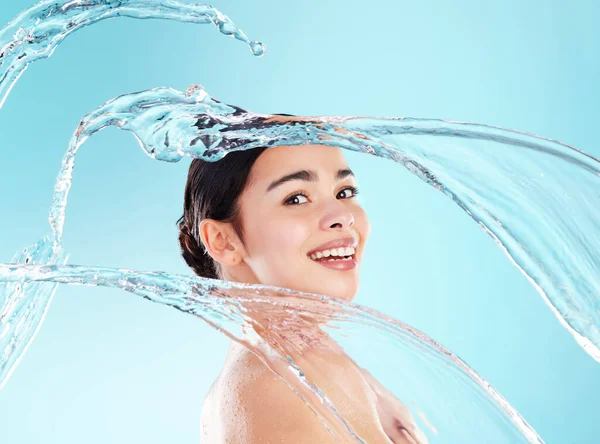 Glow Today. Glow Everyday. a beautiful young woman being splashed with water against a blue background