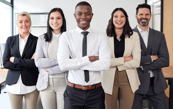 Let us take on the job. a group of businesspeople standing in an office at work